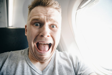 Concept aerophobia. Afraid of fear flying on an airplane and at height