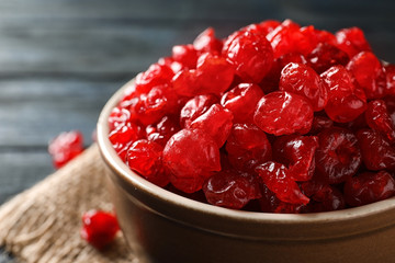 Bowl with tasty cherries on wooden background, closeup. Dried fruits as healthy food