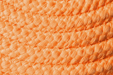 Orange wicker mat texture as background, closeup