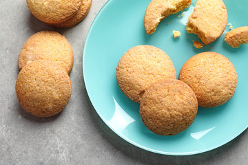 Plate with Danish butter cookies on grey background, top view