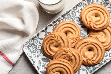 Fototapeta premium Plate with Danish butter cookies on grey background, top view