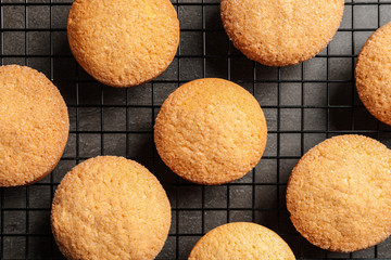 Baking grid with Danish butter cookies on grey background, top view