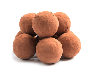 Delicious raw chocolate truffles on white background