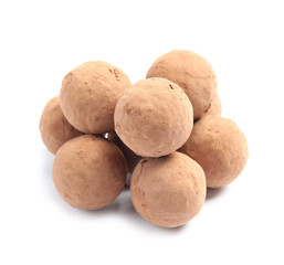 Delicious raw chocolate truffles on white background