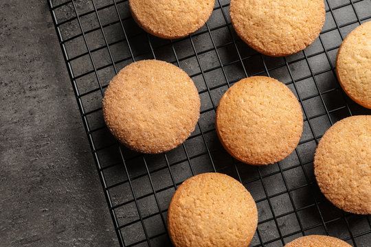 Baking grid with Danish butter cookies on grey background, top view