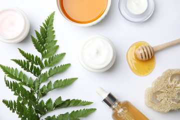 Flat lay composition with different body care products on white background