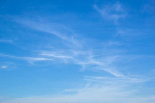 Light white cirrus clouds in the blue sky