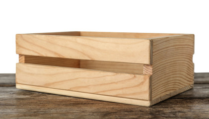Empty rustic wooden crate on table against white background