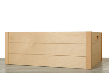 Empty rustic wooden crate on table against white background