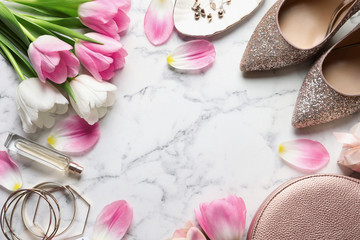 Flat lay composition of beautiful tulips and accessories on marble background, space for text. International Women's Day