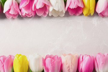 Flat lay composition of beautiful tulips  on marble background, space for text. International Women's Day