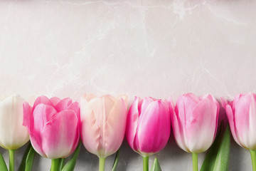 Flat lay composition of beautiful tulips  on marble background, space for text. International...