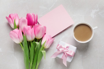 Flat lay composition of tulips and blank card on marble background, space for text. International Women's Day