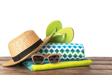 Set of different beach accessories on table against white background. Space for text