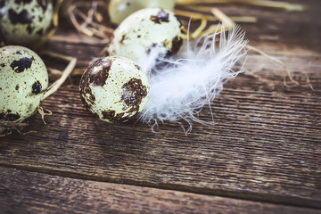 quail and chicken eggs on an old wooden table.