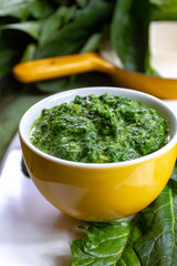 Healthy vegetarian or vegan food, cooked green spinach with cream, ingredient for many dishes like pasta, ravioli or soup