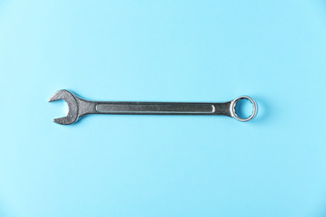 New wrench on color background, top view. Plumber tools