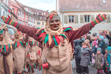 Carnival figure with sackcloth costume with open arms. Street Carnival in Southern Germany - Black Forest.