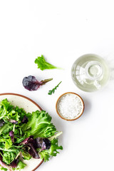 green and red salad mix on plate with salt for healthy food on white background top view mock up