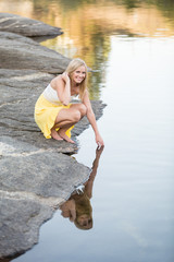 Beautiful young woman playing in water