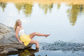 Beautiful young woman playing in water