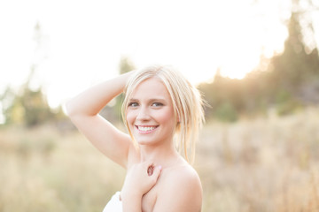 pretty girl smiling at camera in summer
