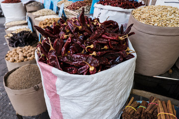 Dry red pepper in bulk surrounded by various spices at Levinsky Tel-aviv market.