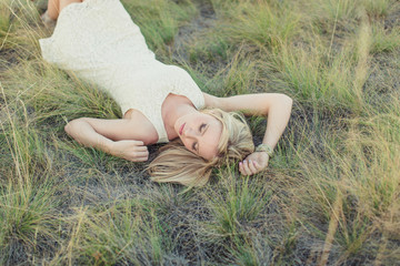 beautiful young girl lying in grass