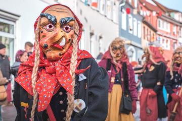Carnival figure with a crooked nose and pigtails. Street Carnival in Southern Germany - Black Forest.