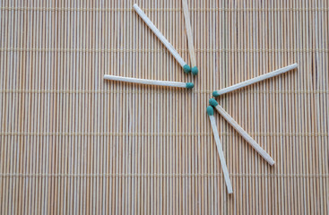 wooden matches with green phosphorous heads are scattered on the table