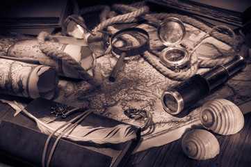 Obraz na płótnie Canvas Old maps and vintage objects on a wooden table, sepia effect