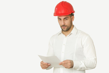 Studio shot of a young businessman wears a red helmet and white shirt