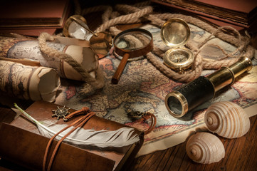 Vintage still life: old maps and vintage objects on a wooden table