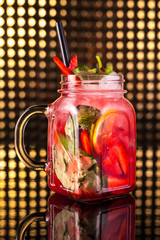 Red fruit cocktail lemonade in vintage jar