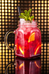 Red fruit cocktail lemonade in vintage jar