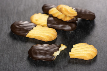 Group of lot of whole two halves of lazy cookie with chocolate on grey stone
