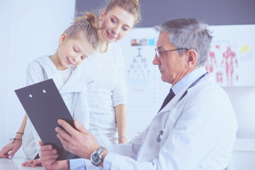 Fototapeta premium Little girl with her mother at a doctor on consultation