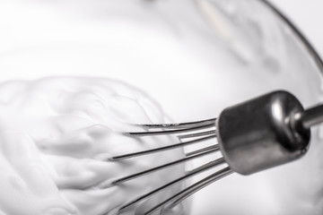 Whipped egg whites for cream on wooden table, top view