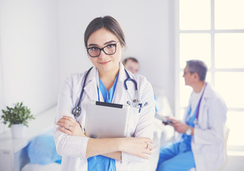 Female doctor using tablet computer in hospital lobby