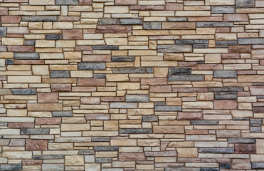 Brown colored stone setting. Cut stone wall texture