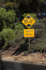 Highway yellow sign, street sign, view from inside a car