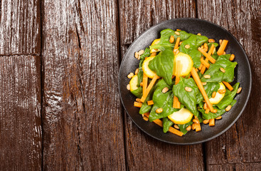 Spinach and carrot salad - Wood background