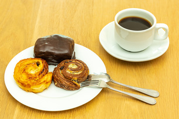 Bread in white dish on wooden table.