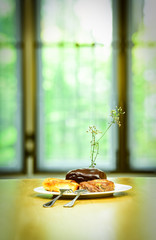 Bread on white dish in blur background.