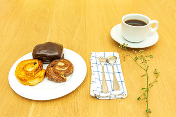 Bread in white dish on wooden table.