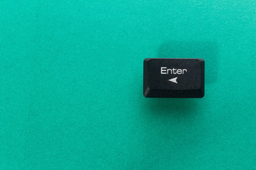 Enter button from the computer keyboard, on a green background.