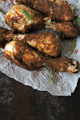 Appetizing chicken legs in breading on paper. Top view.