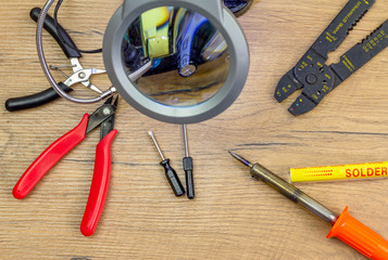 Concept Right to Repair, image showing tools repairing domestic switch under magnification with...