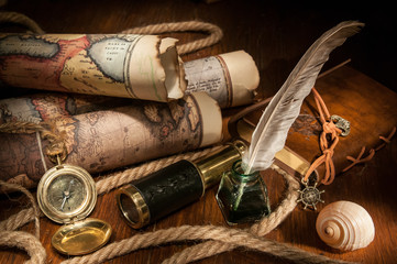 Vintage still life: old maps and vintage objects on a wooden table