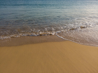 Small waves in an empty beach shore.
